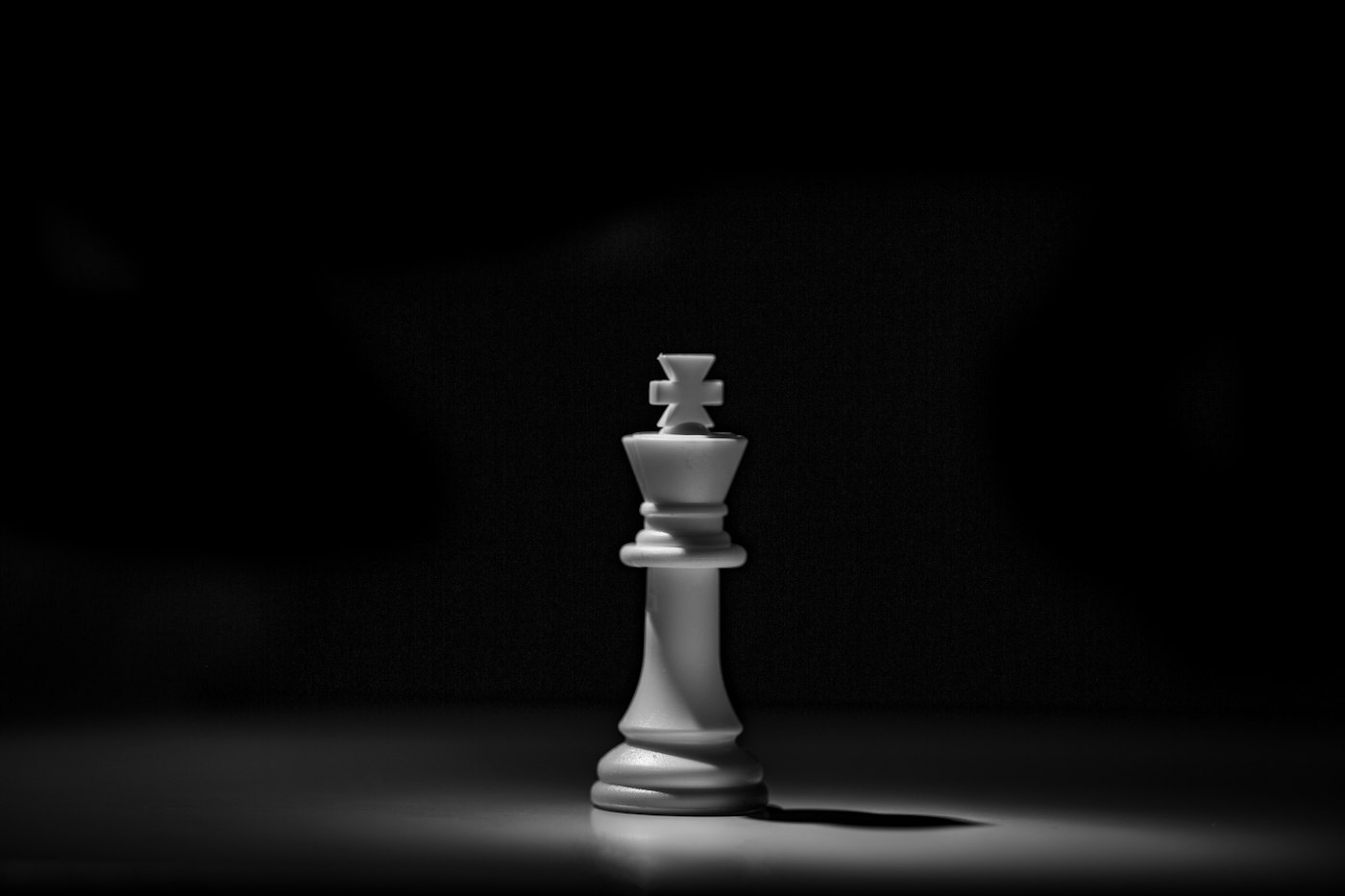 A single white chess piece under a spotlight